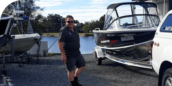 Man Posing With Boats — Boat Shop in Ballina, NSW